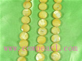 faced yellow button shaped shell strands